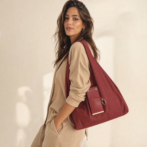 Burgundy foldable tote shopping bag carried by model