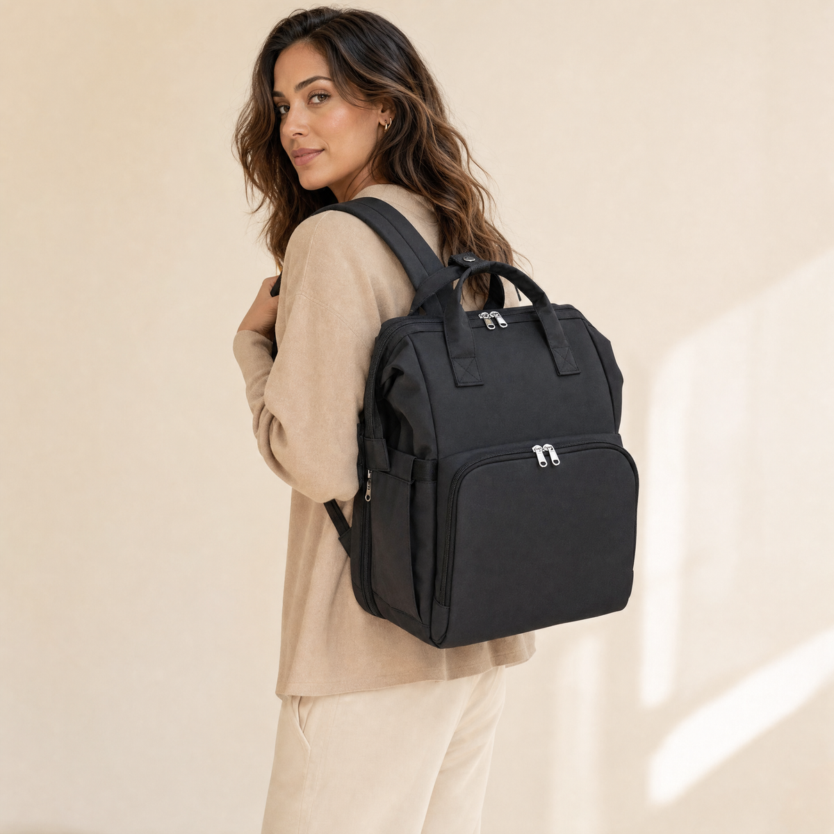 Black foldable diaper bag backpack worn by model