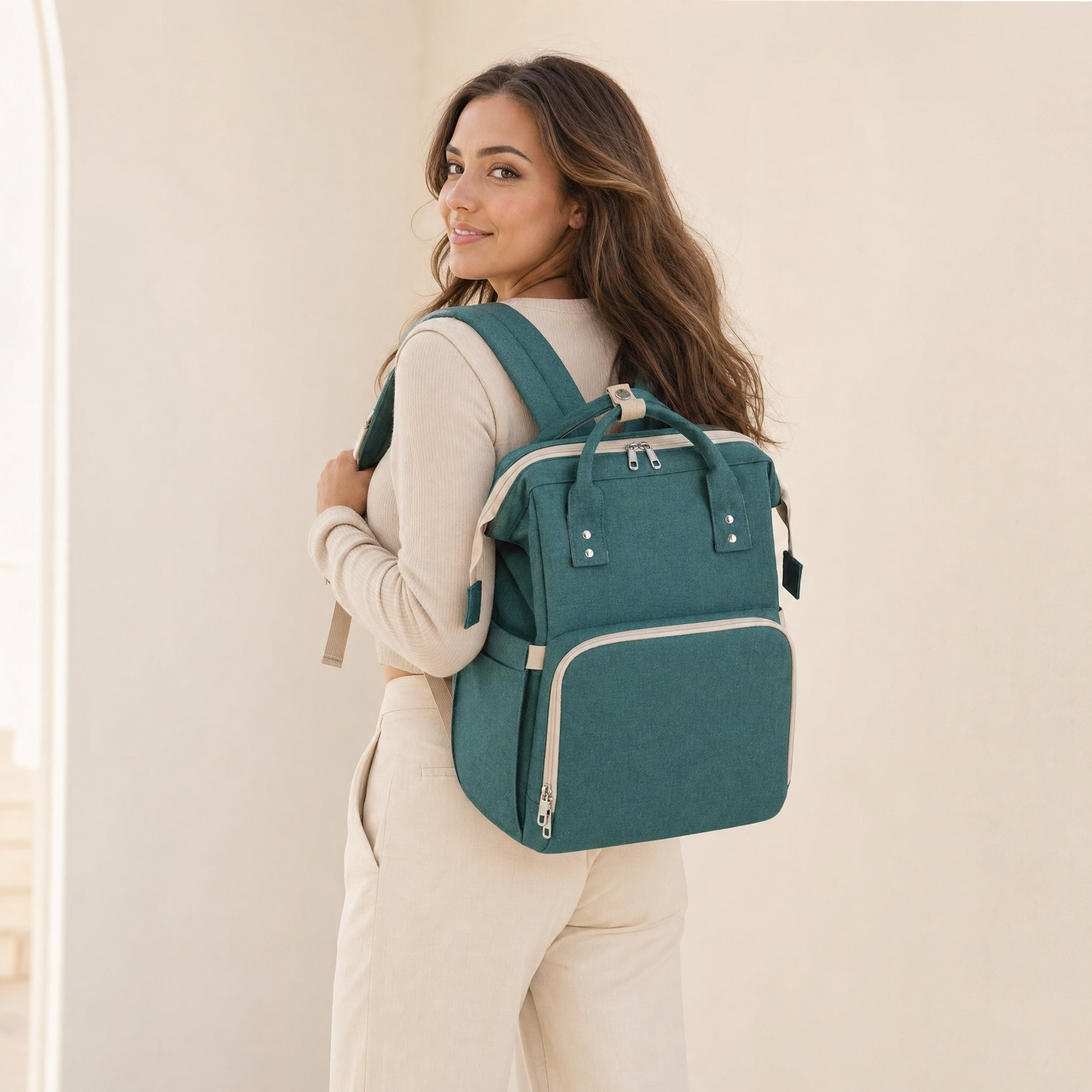 Green foldable diaper bag backpack worn by model