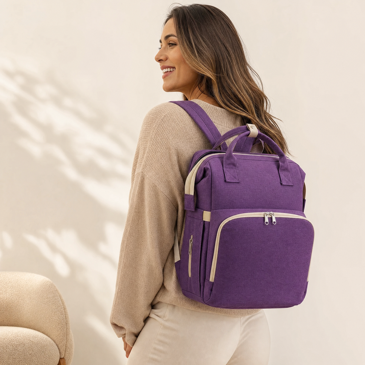 Purple foldable diaper bag backpack worn by model
